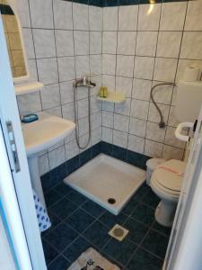 a bathroom with a shower and a toilet and a sink at Vangelis Studios in Skala Potamias
