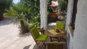 a table and two chairs and a table with fruit on it at Apartments Dora in Crikvenica