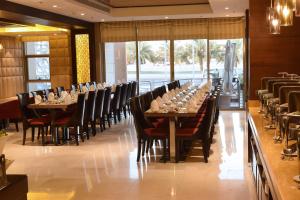 a long dining room with long tables and chairs at Best Plus Aurora Hotel in Riyadh