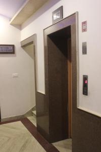 an elevator door in a building with a red light at Hotel Safari in Jaipur