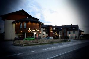 a building with a sign on the side of a street at Hotel Azalia & Spa in Niepołomice
