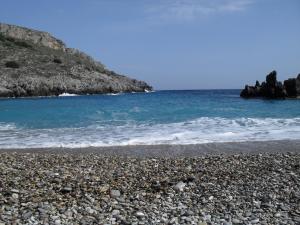 a rocky beach with the ocean in the background at Emmanouil in Kythira