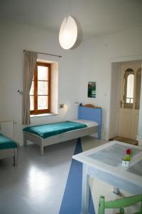 um quarto com duas camas e uma mesa e uma janela em Napkorong Vendégház Feked em Feked
