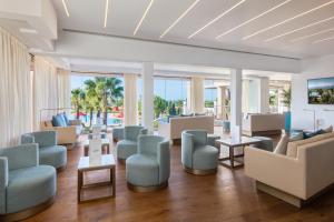 a waiting room at a resort with chairs and tables at Cascade Wellness Resort in Lagos