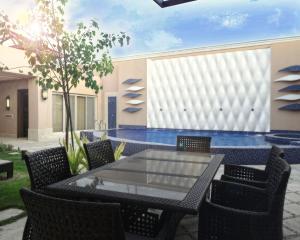 a patio with a table and chairs and a pool at Goot Resorts in Riyadh