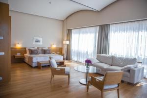 a hotel room with a bed and a couch at ON'LIVE HOTEL in Çeşme