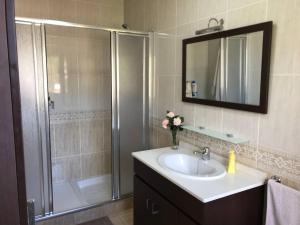 a bathroom with a shower with a sink and a shower at Casa Pío Nigrán, vistas Islas Cíes in Nigrán +25 photos