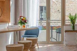 a kitchen with a table and chairs and a balcony at Chandakos 8 Design Apts in Heraklio