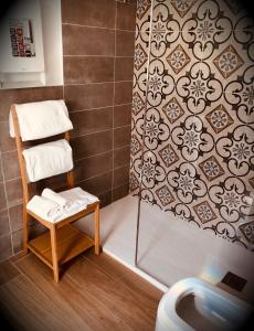 a bathroom with a shower with a towel rack and a toilet at Real Rooms in La Spezia