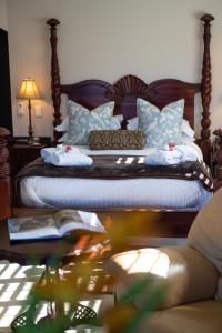 a bedroom with a bed with blue and white pillows at Luxury Beach Apartments in Amanzimtoti