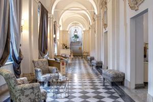 a hallway with chairs and tables in a building at Donna Camilla Savelli - VRetreats in Rome