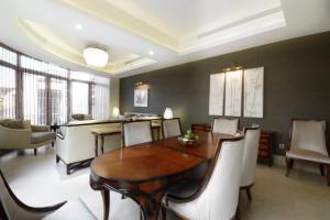 a dining room with a wooden table and chairs at Goot Resorts in Riyadh +60 photos