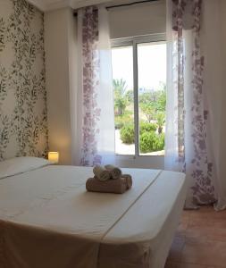 a bedroom with a bed with towels on it at Apartamento Cervantes in Guardamar del Segura