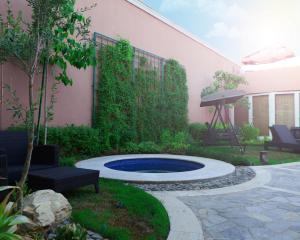 a backyard with a swimming pool and a patio at Goot Resorts in Riyadh