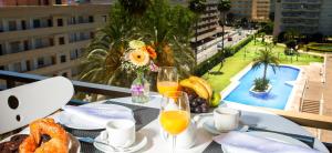 a table with food and drinks on a balcony with a view at Ona Aquamarina in La Pineda