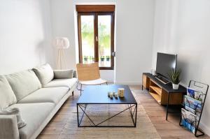 a living room with a couch and a coffee table at Wonderful City Apartment Av Salamanca by NRAS in Alicante