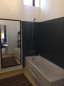 a bathroom with a bathtub and a shower stall at Riad Dar Soufa in Rabat