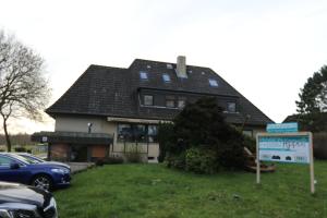 a house with a sign in front of it at Pension Appelt in Cuxhaven