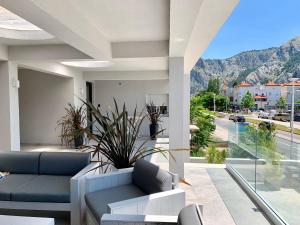 a living room with a couch and a view of a street at Deluxe Suites Mandić in Omiš