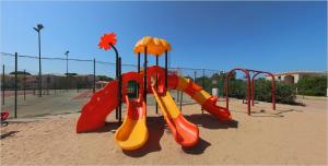 a playground with slides and swings at a park at Club Esse Gallura in Aglientu