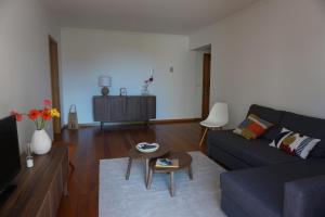 uma sala de estar com um sofá e uma mesa em Freda House no Funchal