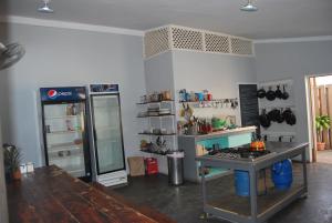 a kitchen with a stove and a refrigerator at Mobay Kotch in Montego Bay