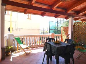 a patio with a table and chairs on a porch at Casale Villa Marzia in Massa Lubrense