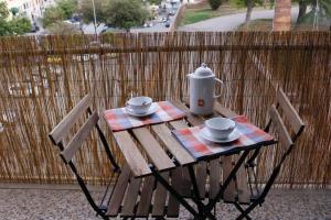 a table with two chairs and a tea kettle on it at The Nest in Grosseto