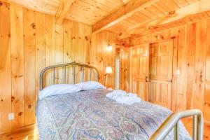a bedroom with a bed in a wooden cabin at Franconia Range View in Franconia