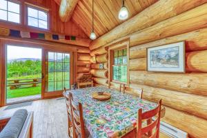 a dining room with a table in a log cabin at Eaglet Log Home in Franconia