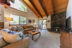 a living room with a couch and a fireplace at Sunriver Resort's Tennis Village 53 in Sunriver