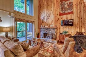 a living room with a couch and a fireplace at Bee Branch 24 in Sugar Mountain