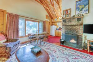 a living room with a fireplace and a table at Emmon's Mittersill Village Chalet in Franconia