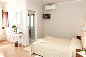 Postel nebo postele na pokoji v ubytování Lu Lioni Rooms