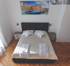 a bedroom with a bed with two white pillows at Apartment LIM in Budva