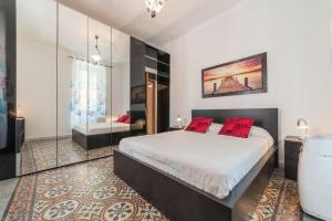 een slaapkamer met een groot bed met rode kussens bij Cozy Flat Borgo Pio in Rome