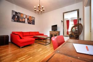 ein Wohnzimmer mit einem roten Sofa und einem Tisch in der Unterkunft Kunterbunt in Naumburg