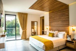 a bedroom with a large bed and a large window at Hotel Pance 122 Wellness Spa in Cali