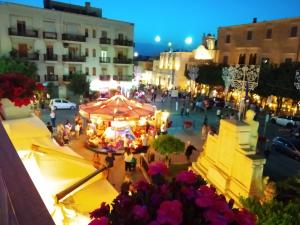 a group of people walking around a street at night at Versomare in Polignano a Mare