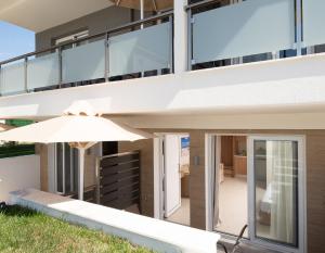 an external view of a house with an umbrella at Astra Sarti Luxury Suites in Sarti