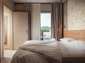 a bedroom with a large bed with a large window at Astra Sarti Luxury Suites in Sarti