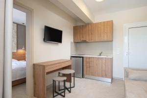 a kitchen with a desk and a sink in a room at Astra Sarti Luxury Suites in Sarti
