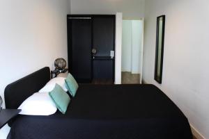 a bedroom with a couch and a bed at TMJ BeB in Porto