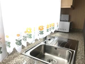 a kitchen counter with a sink and a window at Casa Dos Cabecinhos in Paradamonte +189 photos