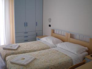 Postel nebo postele na pokoji v ubytování Hotel Del Vecchio