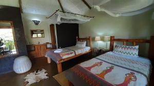 Postel nebo postele na pokoji v ubytování Gately Inn Entebbe