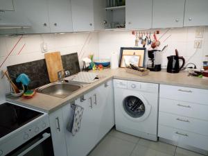 a kitchen with a sink and a washing machine at Siviri, the beautiful sunset in Siviri