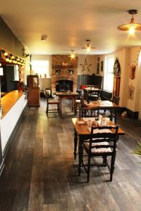 a room with tables and chairs and a fireplace at The Vine B & B in South Thoresby +68 photos