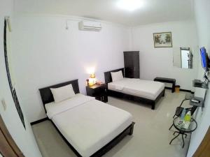 Posteľ alebo postele v izbe v ubytovaní Amaryllis Guesthouse Syariah