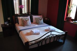 a bedroom with a bed with towels on it at Vienna Story Guesthouse in Mostar +22 photos